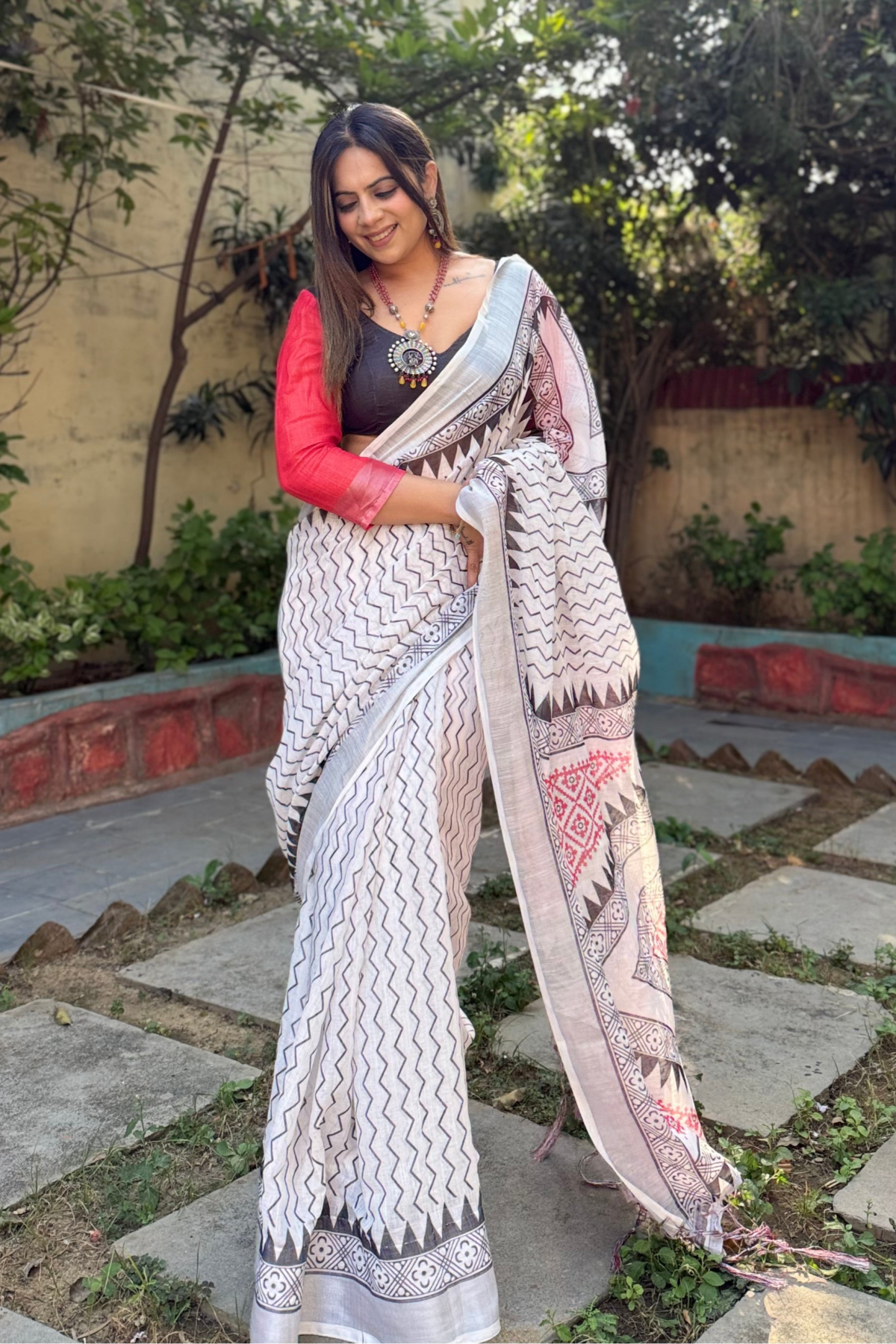 Elegant White Pure Linen Digital Printed Saree with Chevron Design and Intricate Red-Black Geometric Pallu ? Tassel Details and Matching Blouse Piece